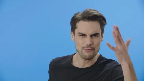 Angry young man arguing while facing the camera Stock Footage 88399805