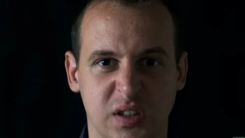 Angry young man on black background Video stock 76526169