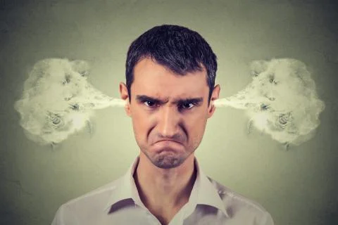 Angry young man, blowing steam coming out of ears Stock Photos