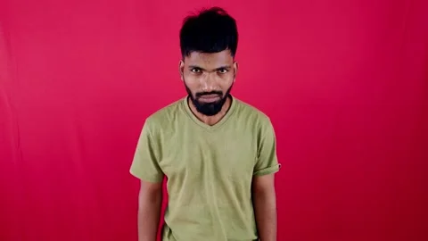 Angry young man depressed posing against red background Stock Footage 262488500