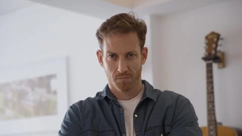 Angry young man. guy looking straight at the camera with an upset expression Stock Footage 316043542