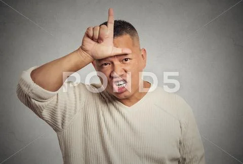 Angry young man showing loser sign on forehead Stock Photos