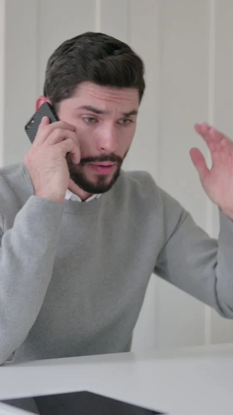 Angry Young Man Talking on Smartphone in Office, Vertical Video Vídeo Stock 339582324