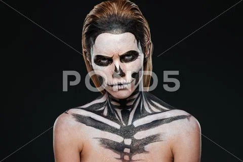 Angry young woman with gothic halloween makeup Stock Photos