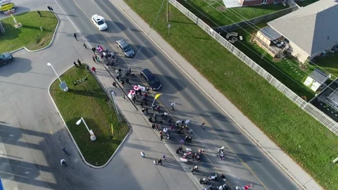 Angular Aerial Of Protestors Marching Down Street By Neighborhood Gas Statio Vídeos de archivo 154876862