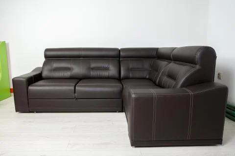 Angular black leather sofa on a neutral background 写真素材