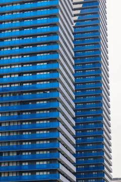 Angular blue balconies line a tall residential complex Stock Photos