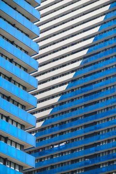Angular blue balconies line a tall residential complex Stock Photos