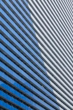 Angular blue balconies line a tall residential complex Stock Photos