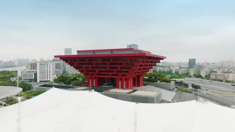 Angular China Art Museum rising over flowing white canopies in Shanghai 스톡 동영상 346607170