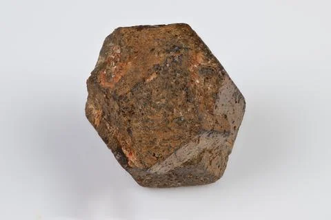 Angular garnet spessartine crystal isolated close up, symmetrical facets with 写真素材