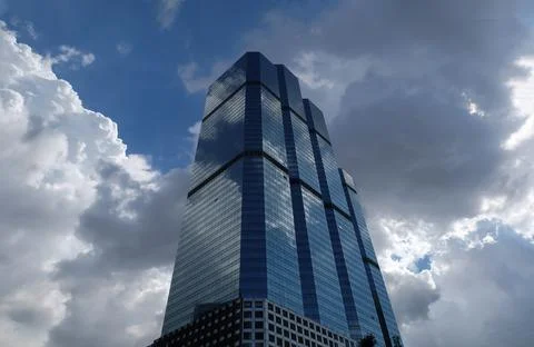 Angular geometric mirror cladding on a modern building with repeating structu Stock Photos