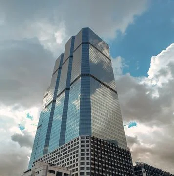 Angular geometric mirror cladding on a modern building with repeating structu Stock Photos
