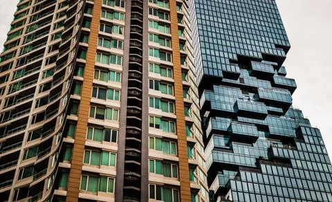 Angular geometric mirror cladding with repeating structure of modern architec Stock Photos