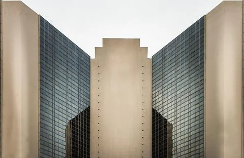 Angular geometric on a modern building with repeating structure and reflected Stock Photos