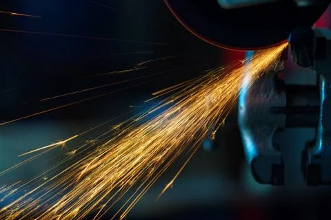Angular grinding machine is cutting the metal and a lot of sparks Stock Photos