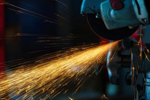 Angular grinding machine is cutting the metal and a lot of sparks Fotos de archivo