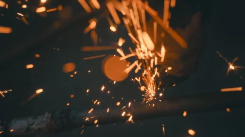 The angular grinding machine is cutting the pipe and flying a lot of sparks  Video stock 64878057