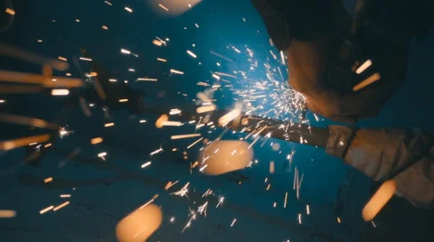 The angular grinding machine is cutting the pipe and flying a lot of sparks  Stock Footage 64878160