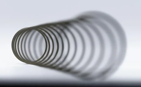 Angular macro view of a  spring with the distant end in focus Foto stock