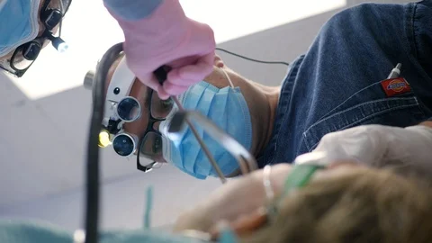 Angular shot of professional dentists using special medical instrument Stock Footage 127001190