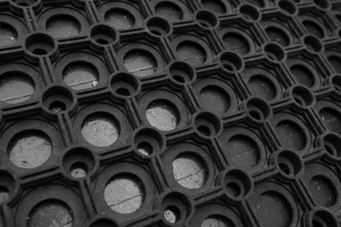 An angular view of a black rubber door mat Foto stock