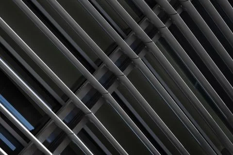 Angular view close-up of dark grey metal beams structure in fragment of building Foto stock