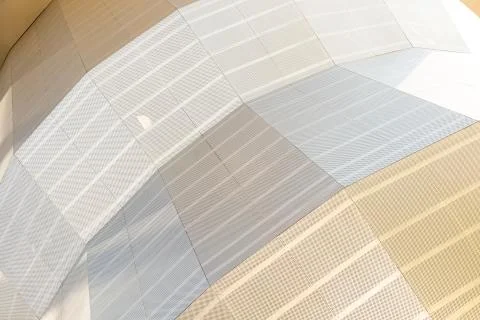 Angular view of geometric surface of light shades with many tiny round openings Stock Photos