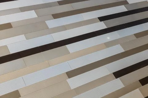 Angular view of metal striped wall of beige and brown color shades with tiny Foto stock