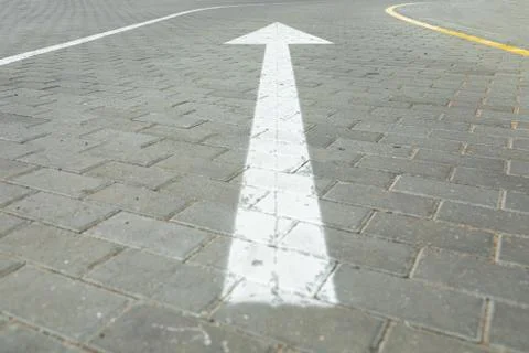 Angular view of road marking white arrow pointing direction for cars Stock Photos