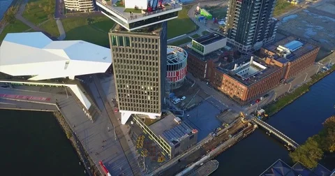 Angular white museum roof beside a tower on the IJ quay Vidéo 71296218