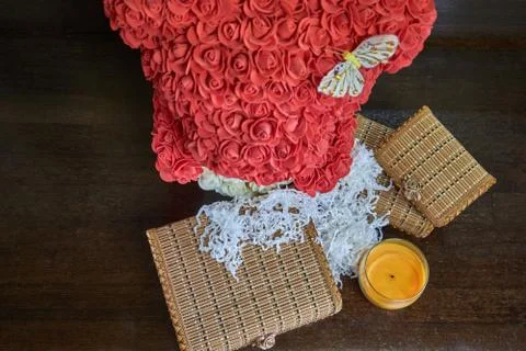 Animal made of artificial roses with chests and a candle Stock Photos
