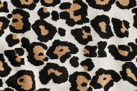 Animal print, leopard pattern fabric background in brown colors Stock Photos