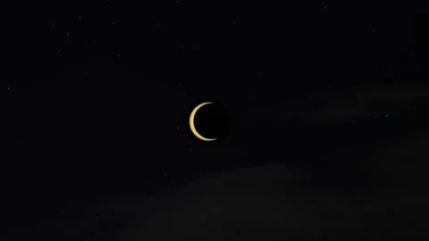 Animated annular solar eclipse phases against a starry sky with clouds Stock Footage 255244455