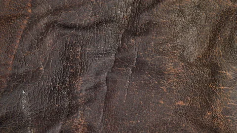 Animated brown leather background. a piece of brown leather with folds. 3d rende Stock Footage 140295700