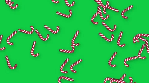 Animated Candy Canes Falling Slowly Over a Solid Green Background Stock Footage 343699061