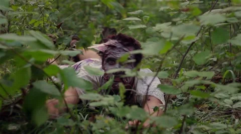 Animated corpse lying in the grass and waving his arms Stock Footage 66572035