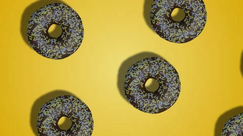 Animated diagonal pattern of donuts with chocolate icing on yellow bg Stock Footage 196479413