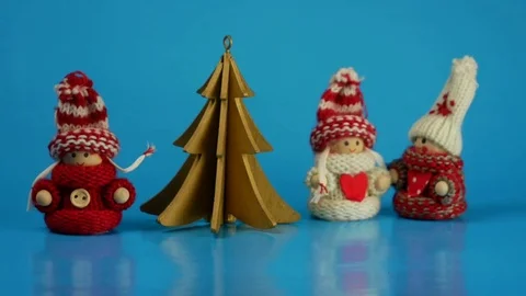 Animated figures in winter clothes dance around the tree. Merry Christmas Stock Footage 83321421