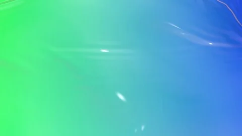 Animated green blue liquid gradient of paint as background in 4k. 3D wavy cloth Stock Footage 119989321