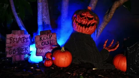 Animated Halloween Pumpkin on dark forest background with signs and raw pumpkins Video stock 140821748