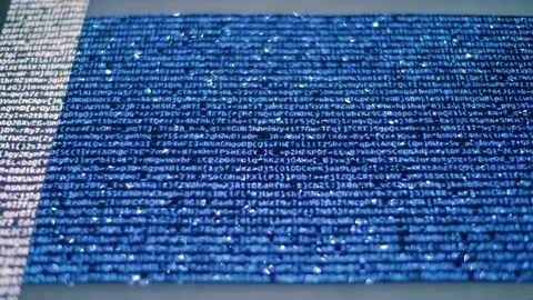 Animated lines of text or program code move across a shiny, sparkling surface Stock Footage 313227868