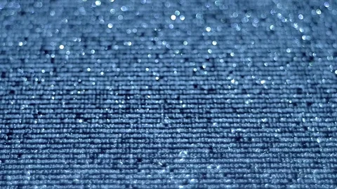 Animated lines of text or program code move across a shiny, sparkling surface Stock Footage 313228380