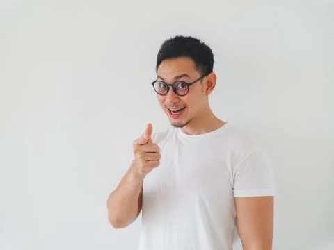 Animated man gesturing confidently towards lens with enthusiasm Stock Photos