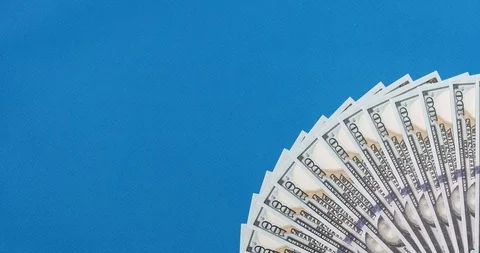 Animated stop motion. Dollars stacked fan on a colored background. Stock Footage 122932488