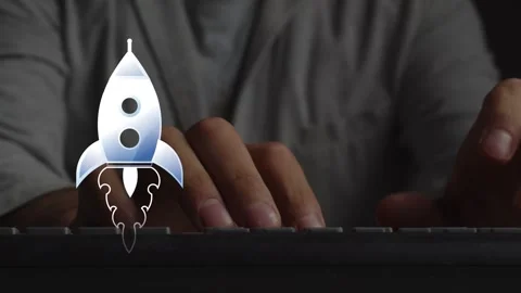 An animated symbol of a flying rocket against the background of a person working Stock Footage 271034821