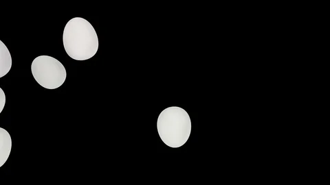 Animated top view of rolling or tumbling from left to right many white eggs Stock Footage 104059042