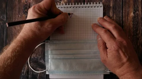 Animated video. a man writing in a notebook with a pencil Stock Footage 142185841