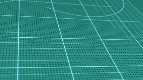 Animated white marking lines are set in place on the green cutting mat Stock Footage 117237653