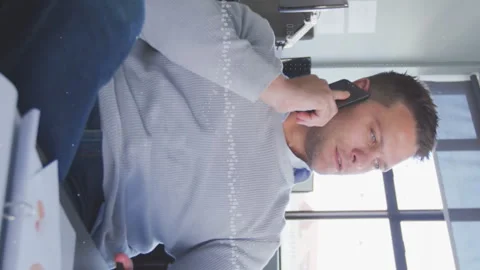 Animation of abstract pattern over caucasian businessman talking on smartphone Stock Footage 312422700